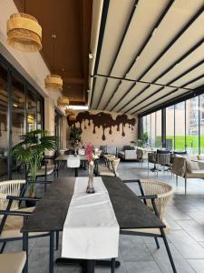 a dining room with a long table and chairs at Sorelle Hotel in Prizren