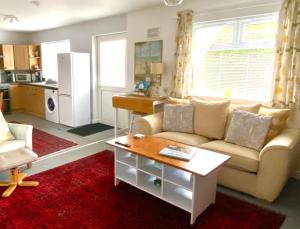 a living room with a couch and a table at Glenburn, Peaceful Accommodation Fochabers in Fochabers