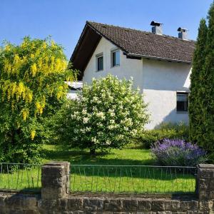 a white house with a fence in front of it at Zimmer, Apartment A3 in Offenberg