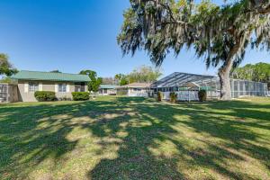 a large yard with a large tree and a house at Lake View, Pool Access! Pet-Friendly Hernando Stay in Hernando