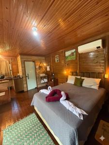 a bedroom with a large bed with towels on it at Loft do Lessa in Ouro Preto