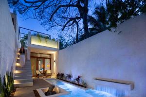 a house with a swimming pool in the backyard at Casa Calma 45 in Mérida