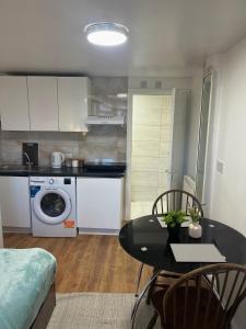 a kitchen with a table and a dining room at Studio near Addenbrookes and Centre By Miller Residence in Cherry Hinton