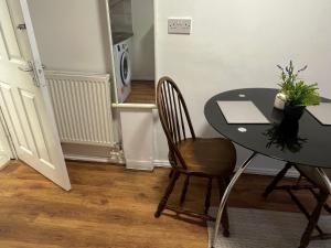 a dining room table with two chairs and a black table at Studio near Addenbrookes and Centre By Miller Residence in Cherry Hinton