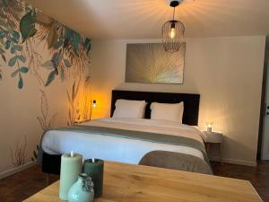 a bedroom with a bed and a table with candles at Charme logies Kampernoelie in Hoeselt
