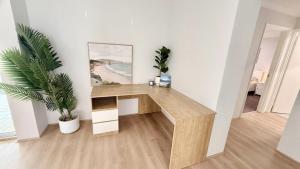 a wooden desk in a white room with a plant at Eagle Breeze in Eaton