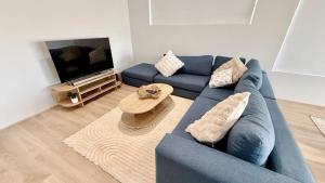 a living room with a blue couch and a tv at Eagle Breeze in Eaton