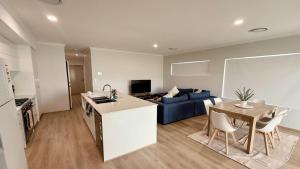 a kitchen and a living room with a blue couch at Eagle Breeze in Eaton