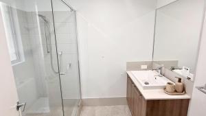 a white bathroom with a shower and a sink at Eagle Breeze in Eaton +14 photos