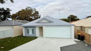 a house with a white garage in a yard at Eagle Breeze in Eaton