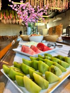 a buffet with several plates of fruit on a table at Village Resort All Fun Inclusive in Jaboticatubas