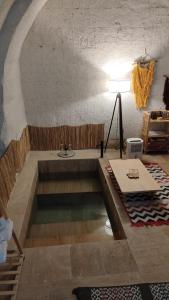 a swimming pool in a room with a table at Route Cappadocia in Avanos