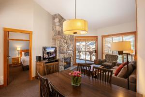 a living room with a dining table and a living room at Legends Whistler, by Lodging Ovations in Whistler