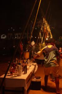 a group of people standing around a table with food at Village Resort All Fun Inclusive in Jaboticatubas +104 photos