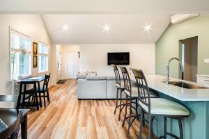 a kitchen and living room with a couch and a table at Harbourview Hideaway Sooke in Sooke
