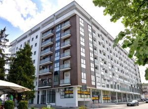 a large apartment building on a city street at Apartman Dora in Jagodina