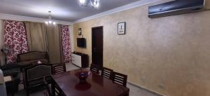 a living room with a dining room table and a couch at Aqua View Chalet at Piacera Resort-Ain Sokhna in Ain Sokhna