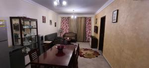 a dining room with a table and a living room at Aqua View Chalet at Piacera Resort-Ain Sokhna in Ain Sokhna