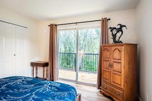 a bedroom with a bed and a large window at Harbourview Hideaway Sooke in Sooke