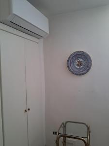 a plate hanging on a wall next to a chair at L'edera in Tuscania +21 photos