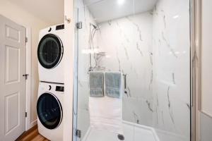 a laundry room with a washer and dryer at Harbourview Hideaway Sooke in Sooke +23 photos