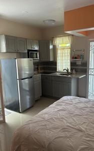 a kitchen with a stainless steel refrigerator and a sink at Zoë Oasis - #1 Couple's Choice & Wholesome Getaway in Lilliendahl