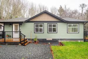 a home with a green house at Harbourview Hideaway Sooke in Sooke