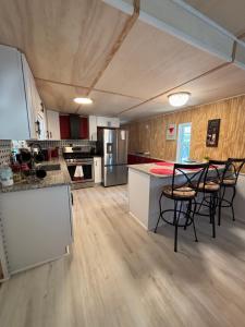 a kitchen with tables and chairs in a room at Prime Crystal River location! in Crystal River