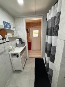 a small bathroom with a black and white shower curtain at Prime Crystal River location! in Crystal River +20 photos