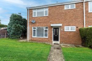a red brick house with a black door at Modern 3BR Durham Stay for Work Trips in Brandon