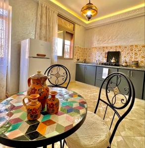 a kitchen with a table with two vases on it at Marrakech home in Marrakesh