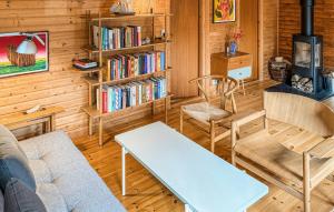 a living room with a couch and chairs and a book shelf at Cozy Home In Stege With Wifi in Stege