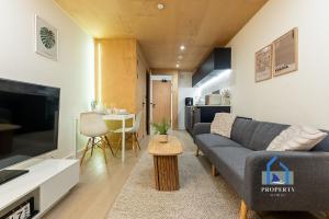 a living room with a couch and a table at Central Manchester Duplex - Balcony - Roof Terrace - Parking in Manchester