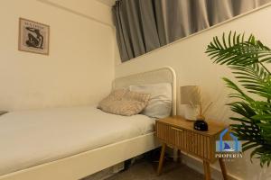 a small bedroom with a bed and a table at Central Manchester Duplex - Balcony - Roof Terrace - Parking in Manchester