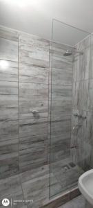 a glass shower in a bathroom with a sink at Quimey Ruca Alojamientos in Neuquén +29 photos