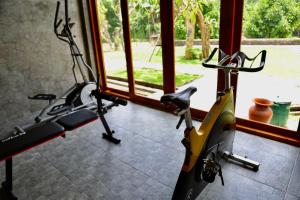 a gym with a moped parked next to a door at Rumah Hadeka sawan in Sawan