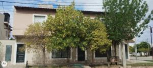 a house with trees in front of it at Quimey Ruca Alojamientos in Neuquén