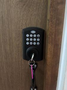 a key hanging from a door with a key chain at La Estancia del Rey David in San Luis Potosí