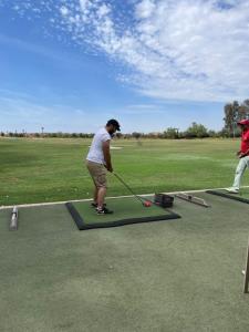 a man playing golf on a putting green at Riad OUAR - Once Upon A Riad in Marrakesh