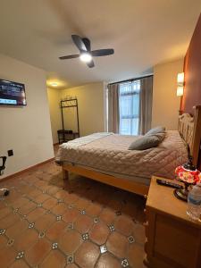 a bedroom with a bed and a ceiling fan at La Estancia del Rey David in San Luis Potosí +52 photos