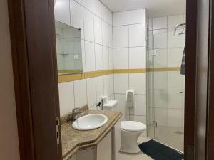 a bathroom with a sink and a toilet and a shower at 101 - Saint Sebastian Flat in Jaraguá do Sul +7 photos