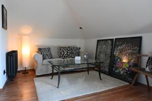 a living room with a couch and a glass table at Villa Hortensie in Aachen