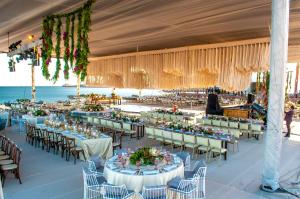 a banquet hall with tables and chairs and the ocean at Marinaterra Hotel & Spa in San Carlos +61 photos