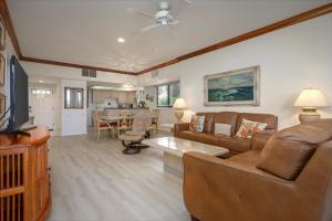 a living room with a couch and a table at Waikoloa Fairways Unit A207 Golf Ocean View 2BD 2BA in Waikoloa Village