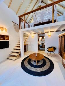 a living room with a table and a spiral rug at Leeloo Boutique Hotel in Las Terrenas