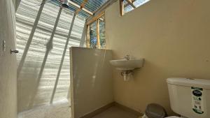 a bathroom with a sink and a toilet at El Tiklan Glamping in Chucchilán