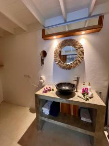 a bathroom with a sink and a mirror on the wall at Leeloo Boutique Hotel in Las Terrenas