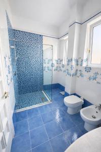 a blue tiled bathroom with a shower and a toilet at Panoramic Apartment Sea & Vesuvio View, Sorrento Center, COSTA DEL SOLE in Sorrento +33 photos