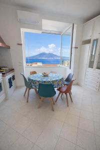 a dining room with a table and a view of the ocean at Panoramic Apartment Sea & Vesuvio View, Sorrento Center, COSTA DEL SOLE in Sorrento