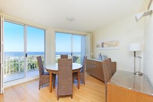 a dining room with a table and chairs and the ocean at Salt Beach Resort Suites by Kingscliff Accommodation in Kingscliff